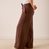 Espresso wide-leg pants in a soft knit fabric with an elastic waistband and side pockets.