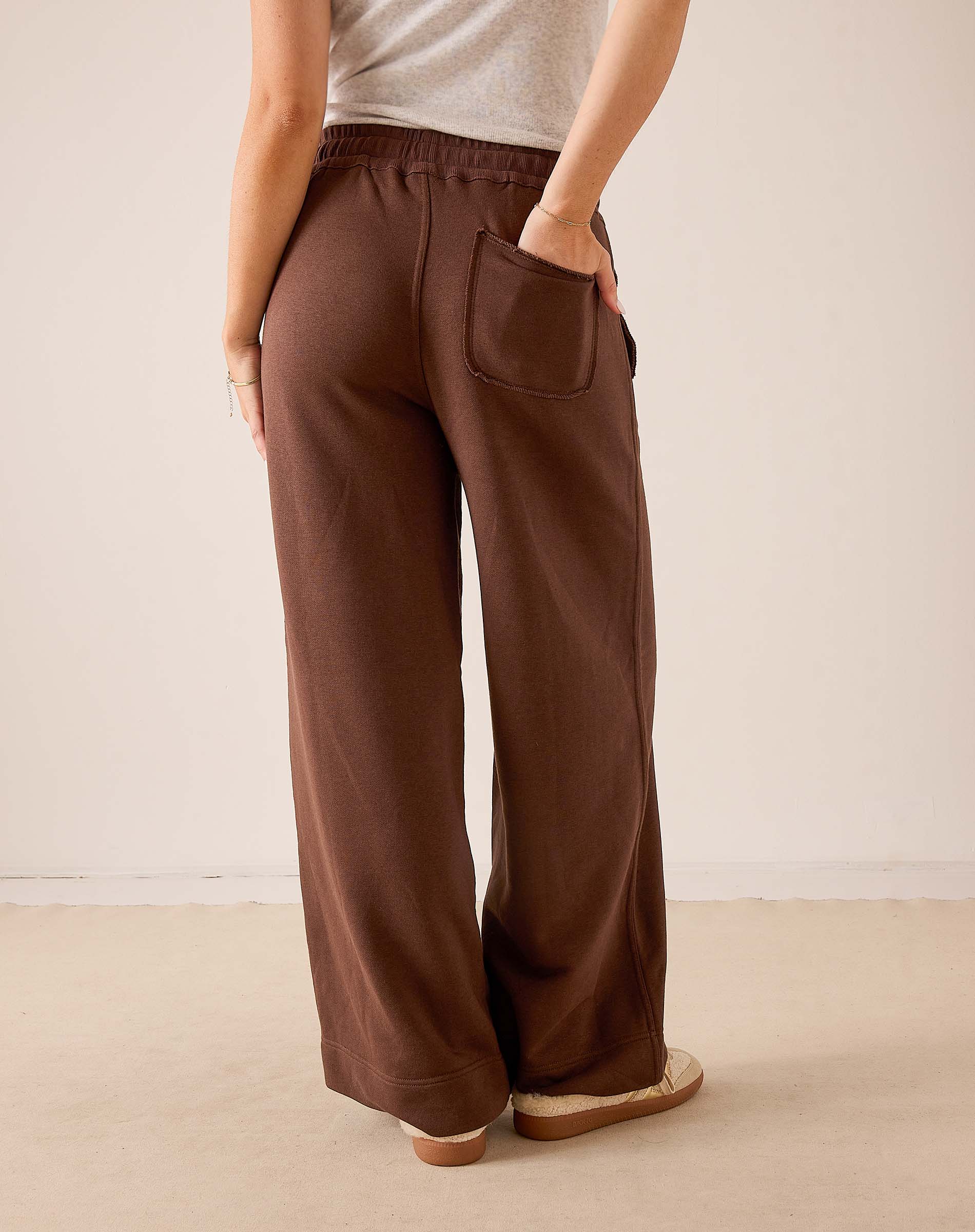 Espresso brown wide-leg pants in a soft knit fabric with a front patch pocket.