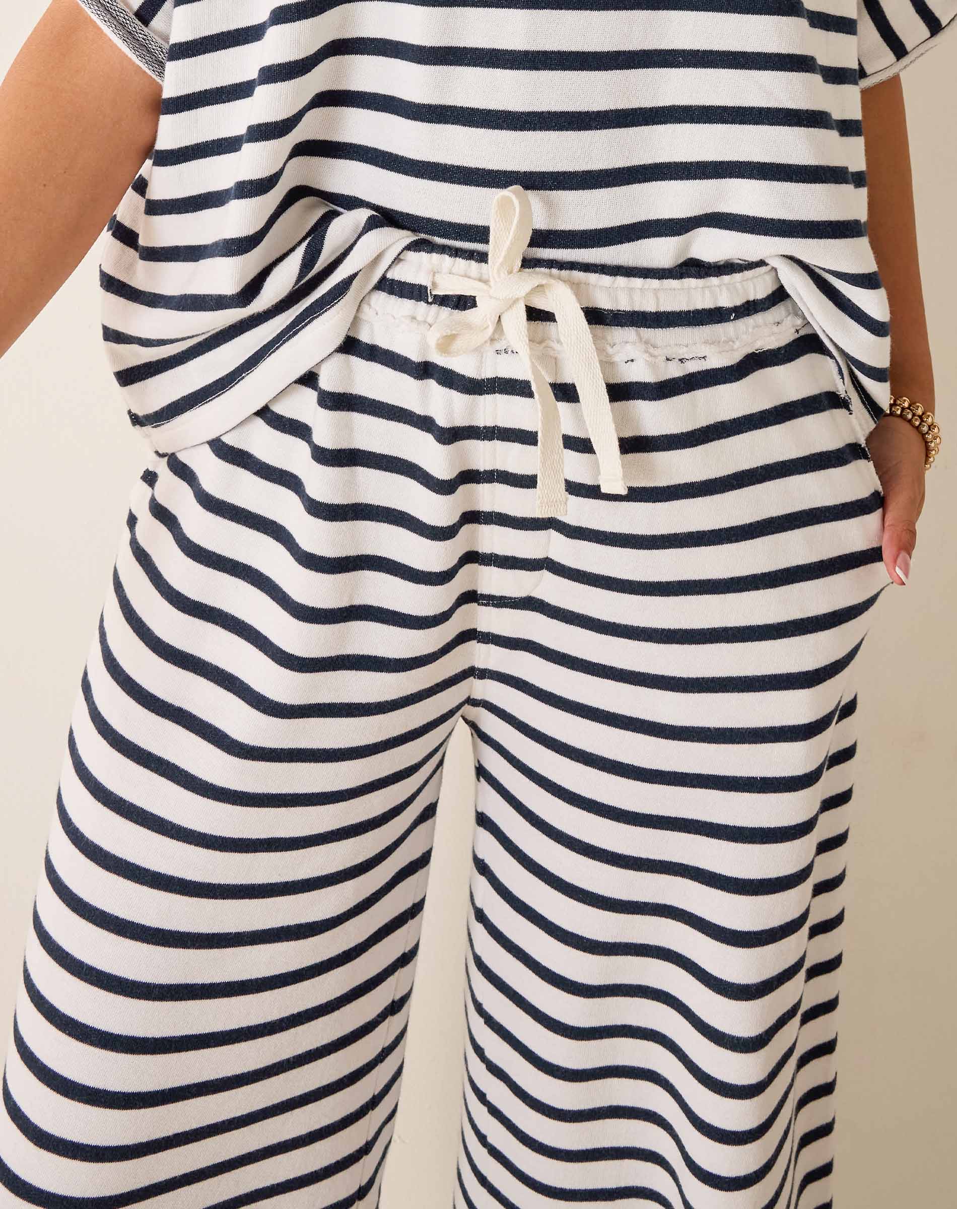 Nautical striped outfit with a top and wide-leg pants on a neutral background