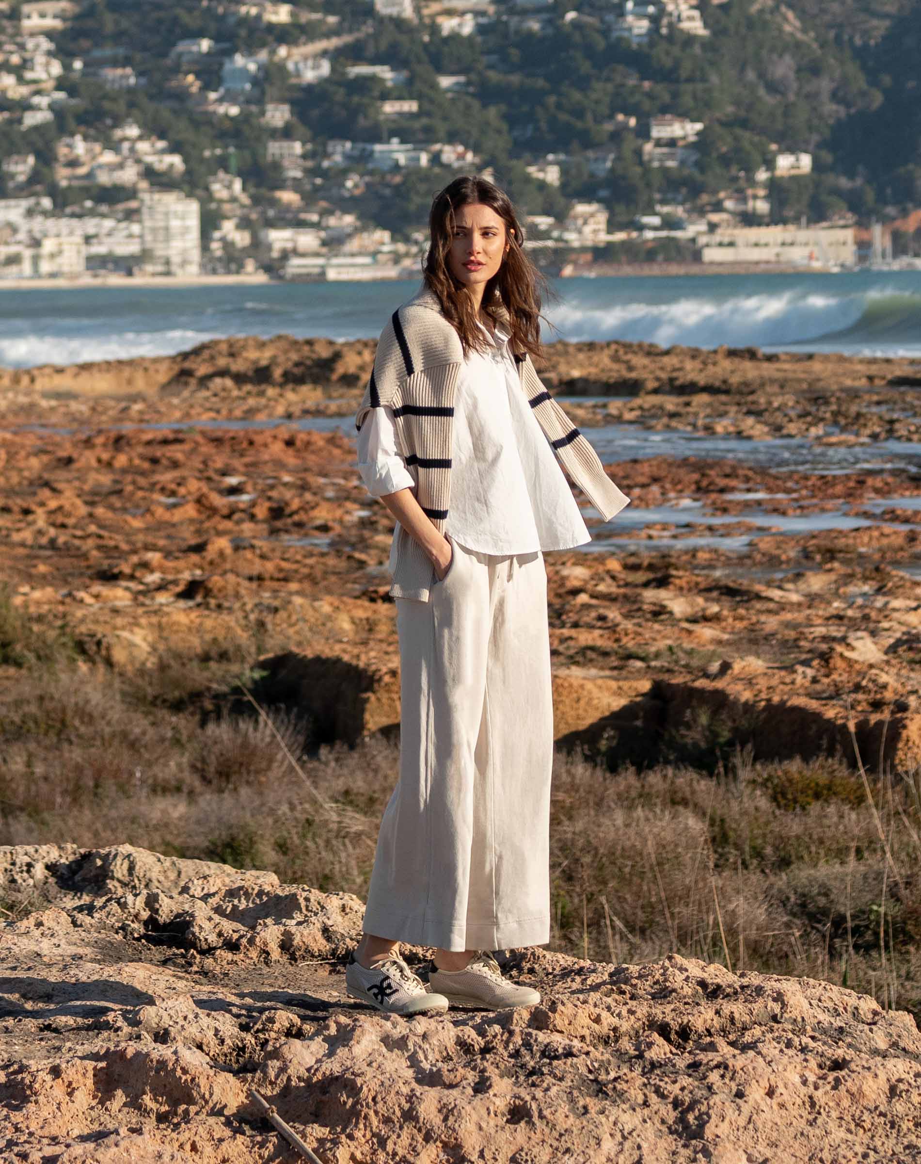 MERSEA women's travel-friendly bone wide-leg pants paired with a striped knit top in a coastal setting.