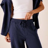 Cadet blue wide-leg pants with a drawstring waist and soft knit finish.