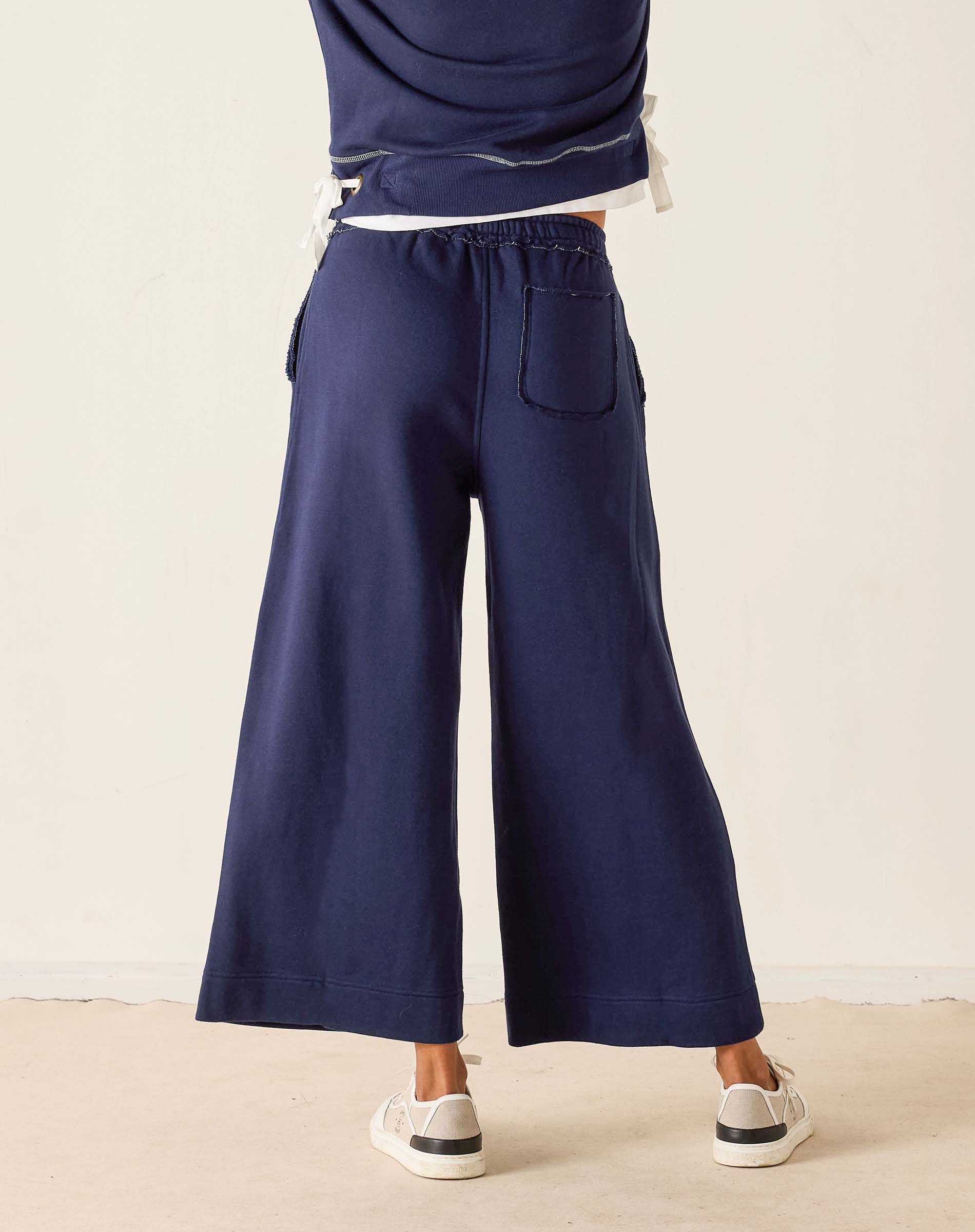 Navy blue wide-leg pants worn by a person on a plain background