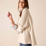 Bone crewneck knit top with folded cuffs and a light blue interior accent.
