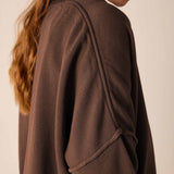 Side view of the espresso knit crewneck top with a decorative zipper detail.