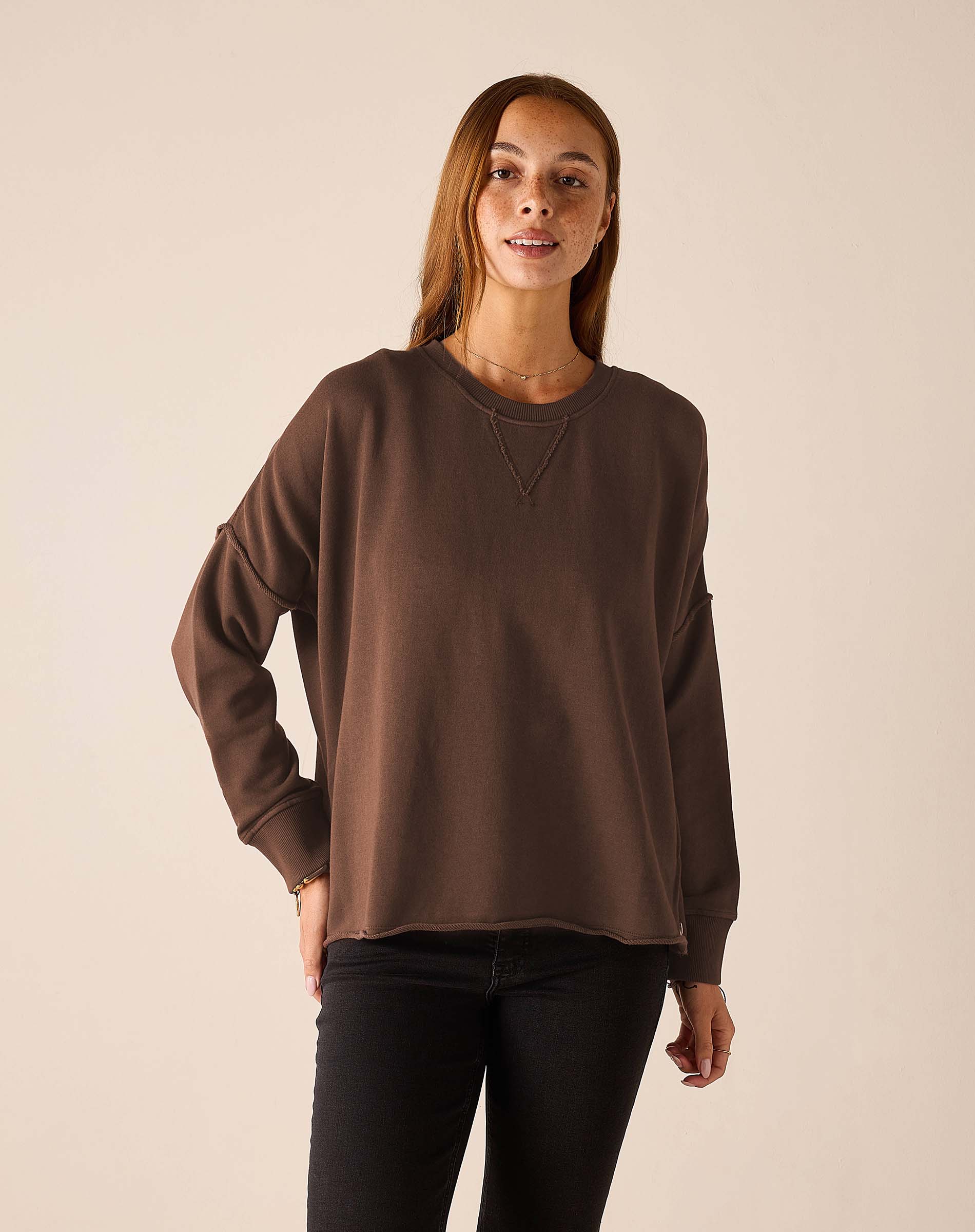 Espresso brown crewneck knit top with long sleeves and a relaxed fit