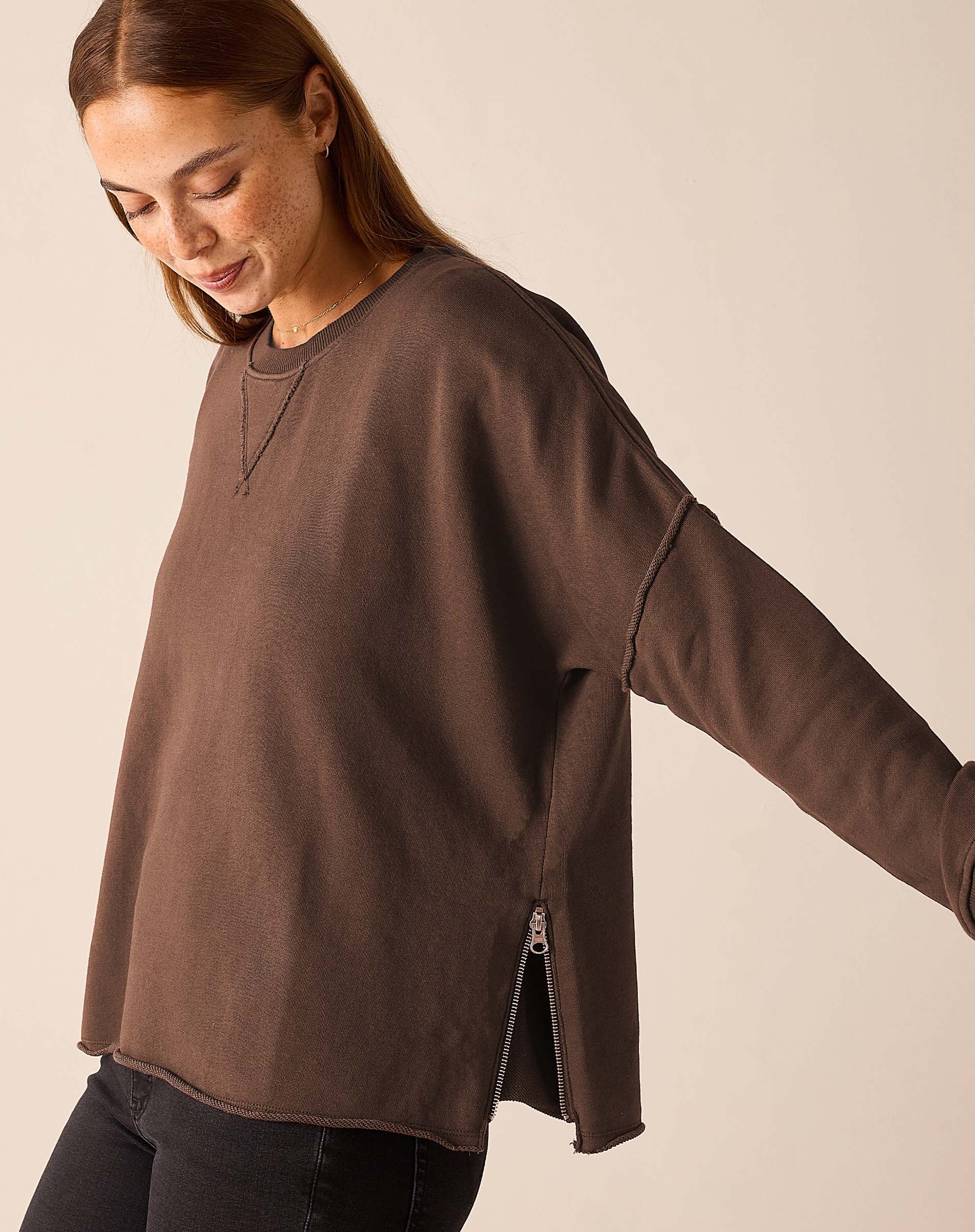 Espresso brown knit crewneck top with a zip detail and relaxed fit.