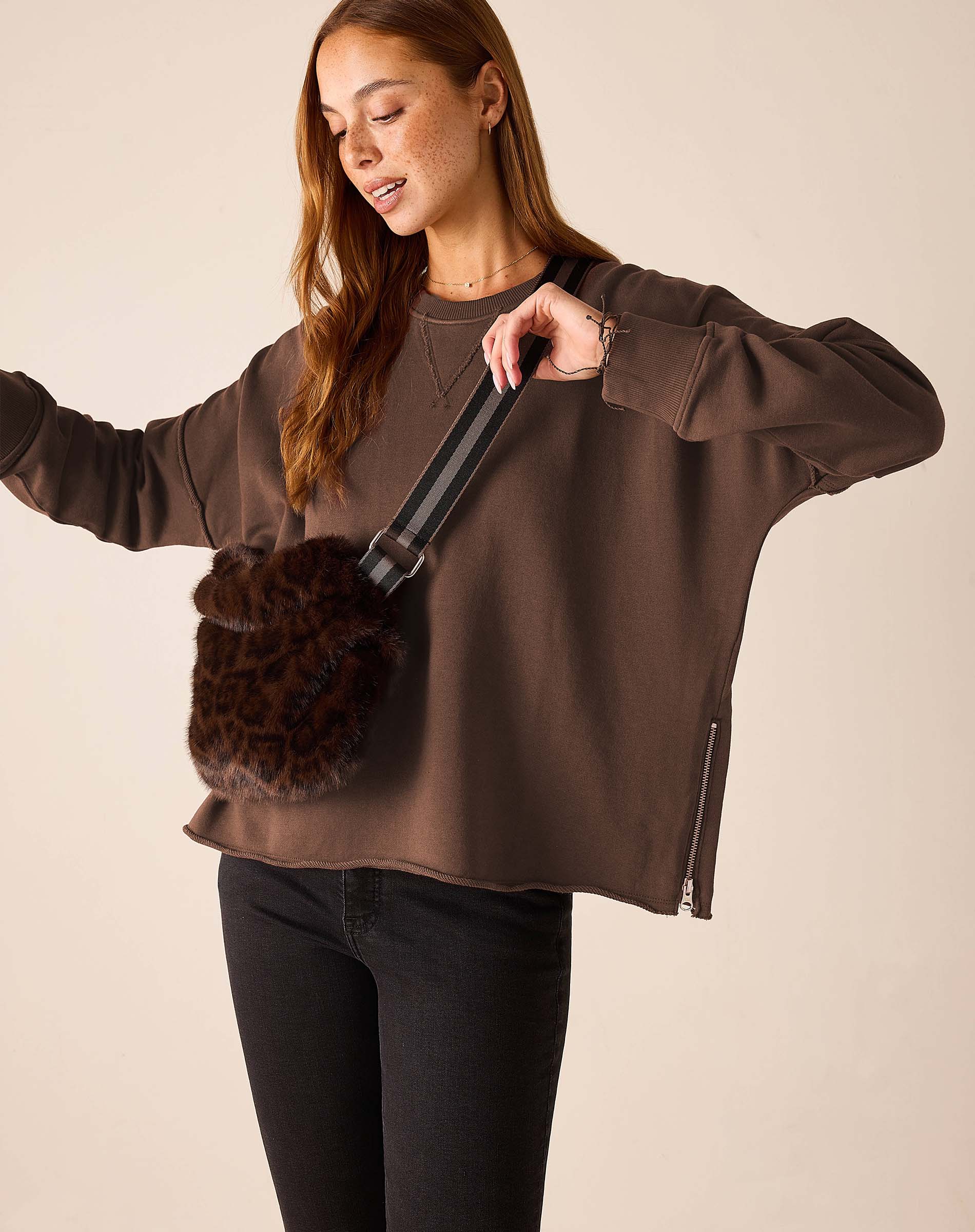 Espresso brown knit crewneck pullover with a zipper side pocket.