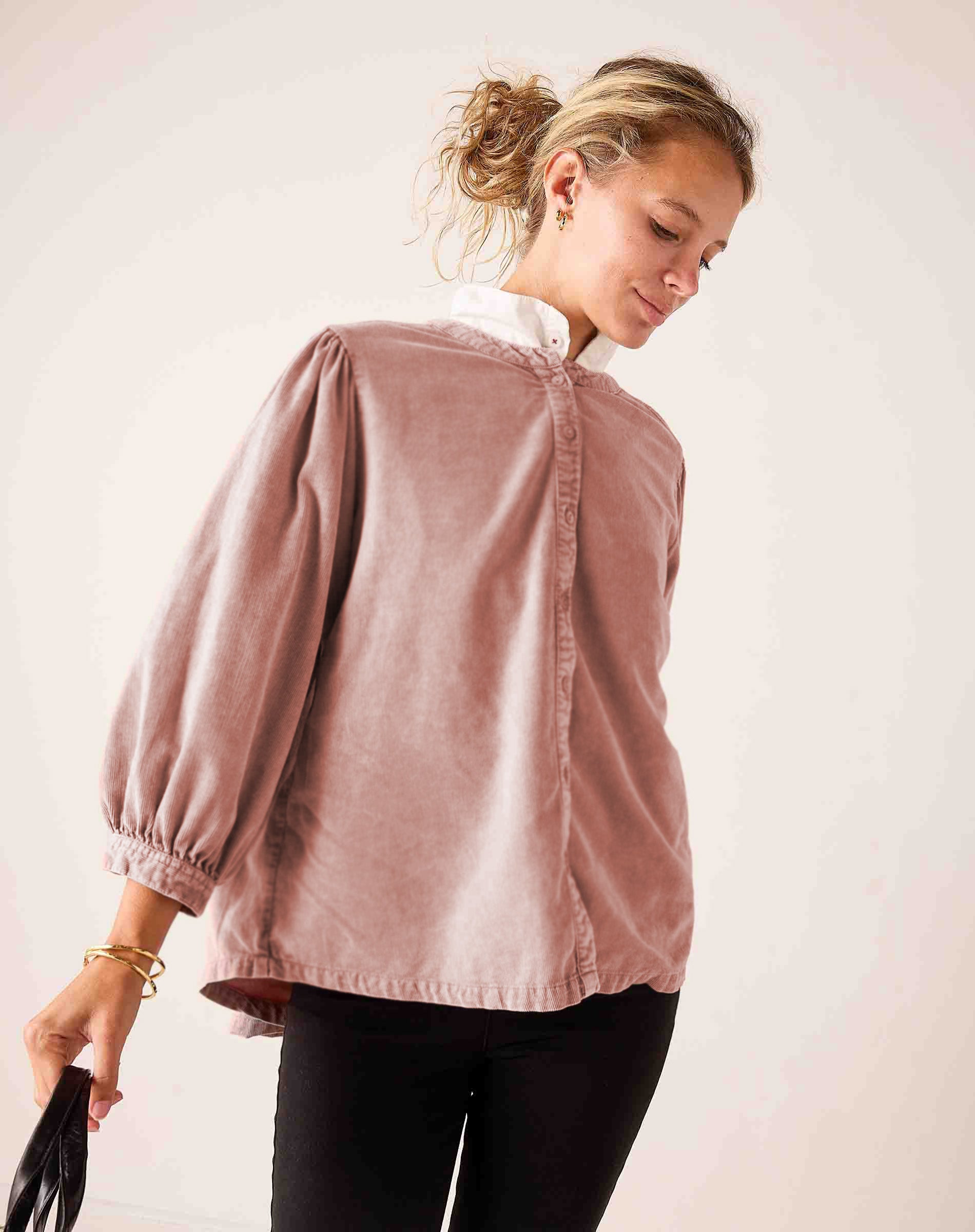 Ladies' travel-ready blush pink oversized puff sleeve cotton-blend blouse with a white ruffled collar.