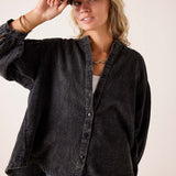 Noir oversized linen-blend button-down shirt with ruffled cuffs.