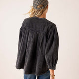 Back view of women's travel-friendly noir oversized linen-blend shirt with gathered puff sleeves and a relaxed fit.
