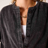 Noir button-down shirt with a ribbed knit texture and a stand collar.