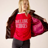Leopard print faux fur lined reversible jacket in brown and tan with a red interior lining.