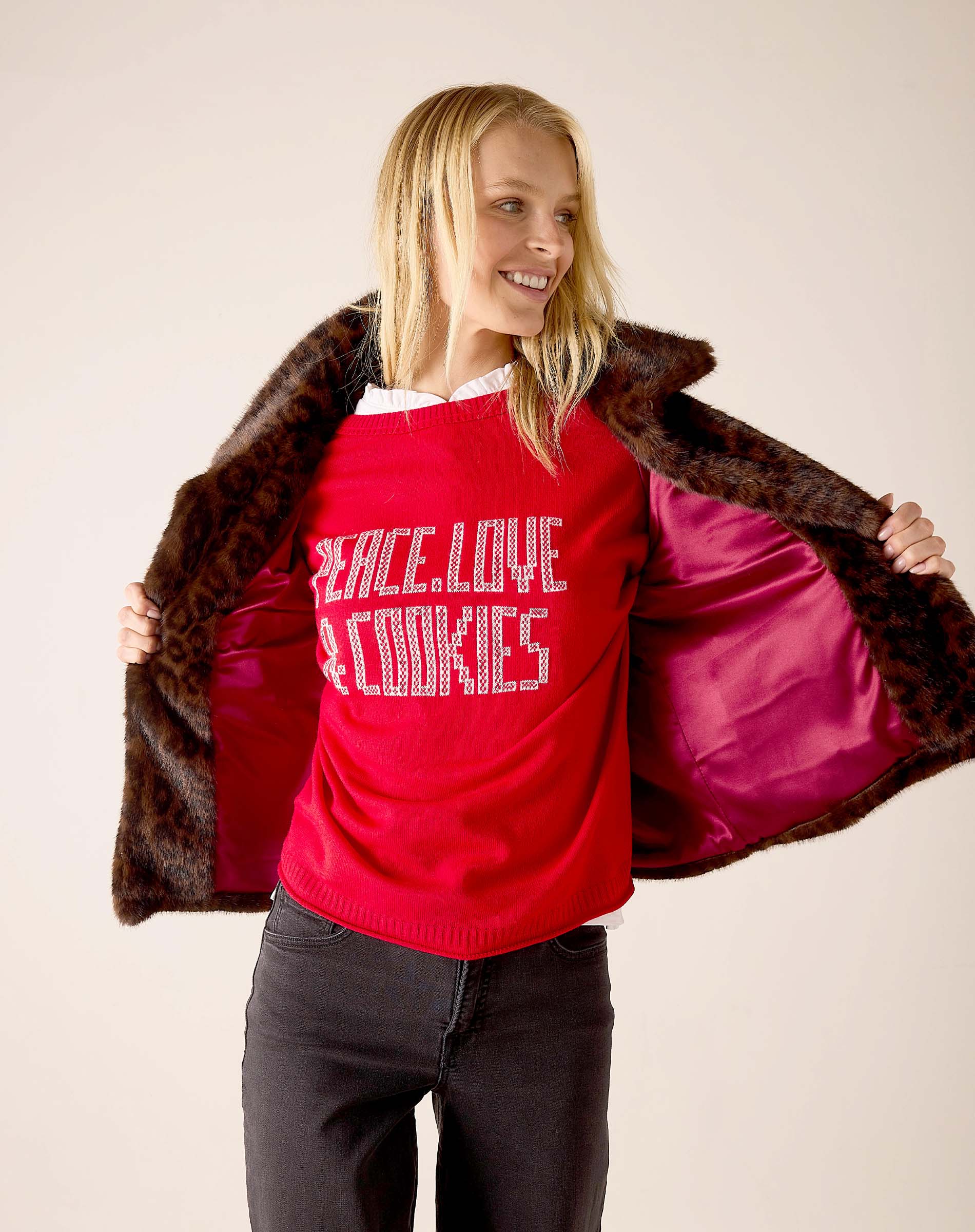 Leopard print faux fur lined reversible jacket in brown and tan with a red interior lining.