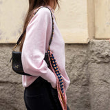 Ballet pink knit sweater with a relaxed fit and long sleeves.