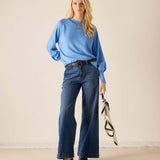 Ladies' travel-ready cobalt blue oversized knit sweater with voluminous sleeves and a ribbed hem.