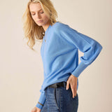 Cobalt blue cashmere sweater with a round neckline and ribbed cuffs.