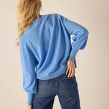 Cobalt blue oversized knit sweater with gathered balloon sleeves and ribbed trim.