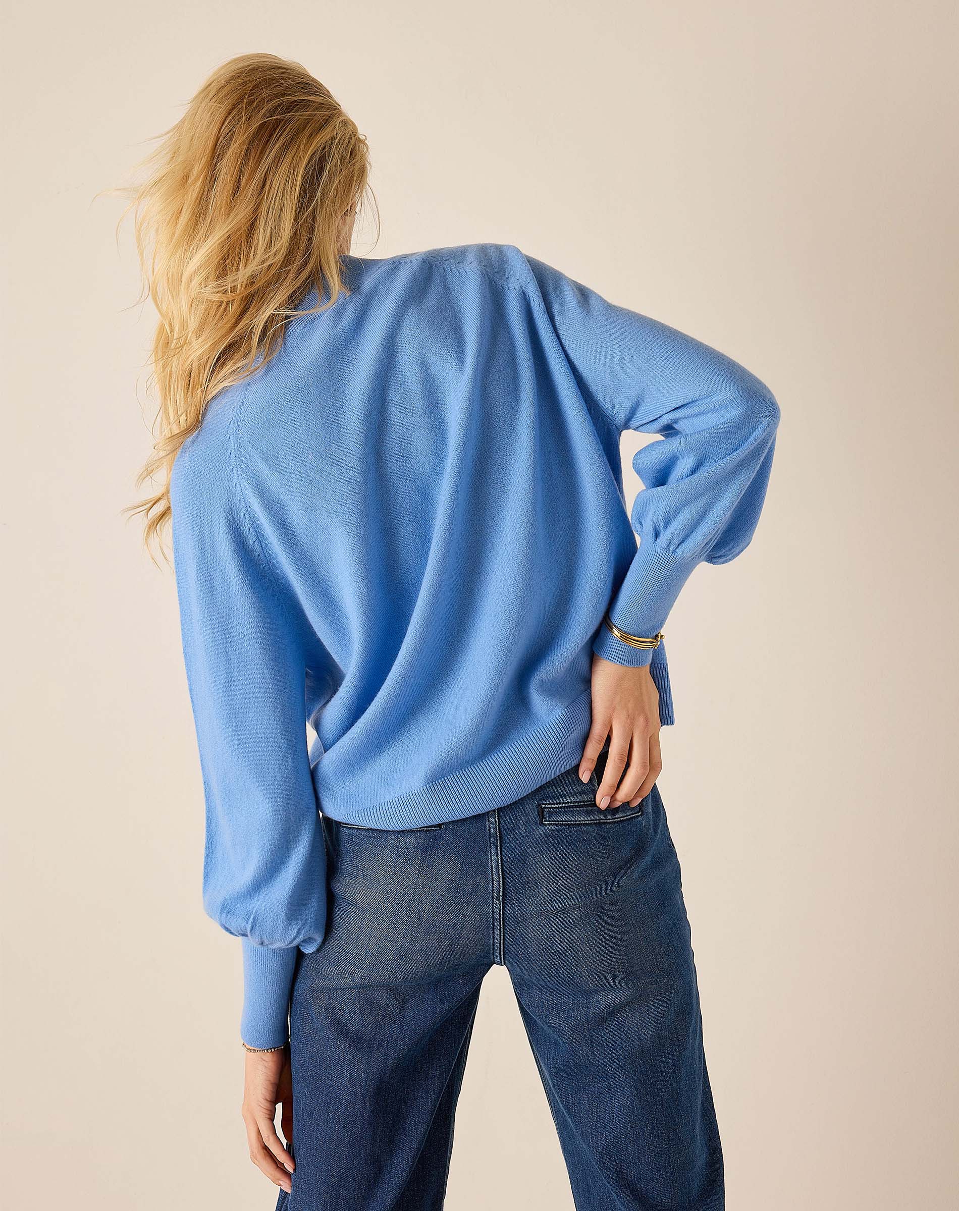 Cobalt blue oversized knit sweater with gathered balloon sleeves and ribbed trim.