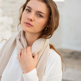 close up of woman wearing golightly scarf around neck in moonstone