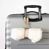 suitcase with golightly travel strap hooked onto handle