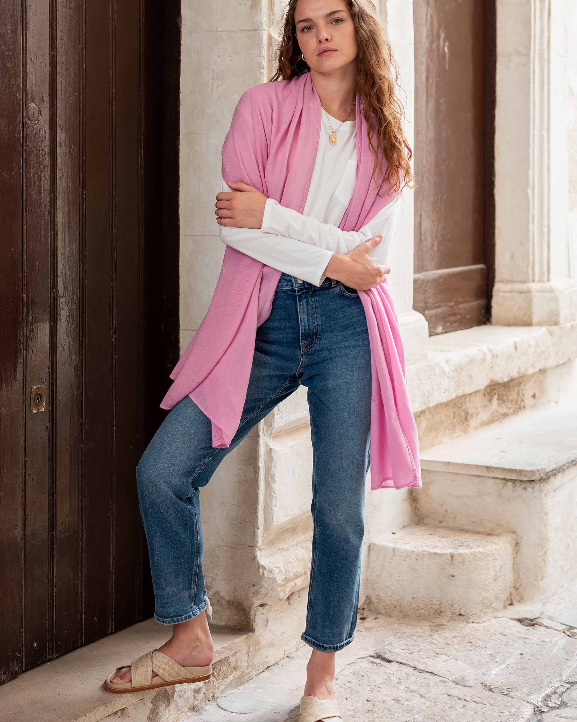 woman wearing golightly scarf around shoulders in pink
