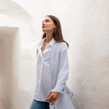 woman looking up wearing golightly scarf in sky