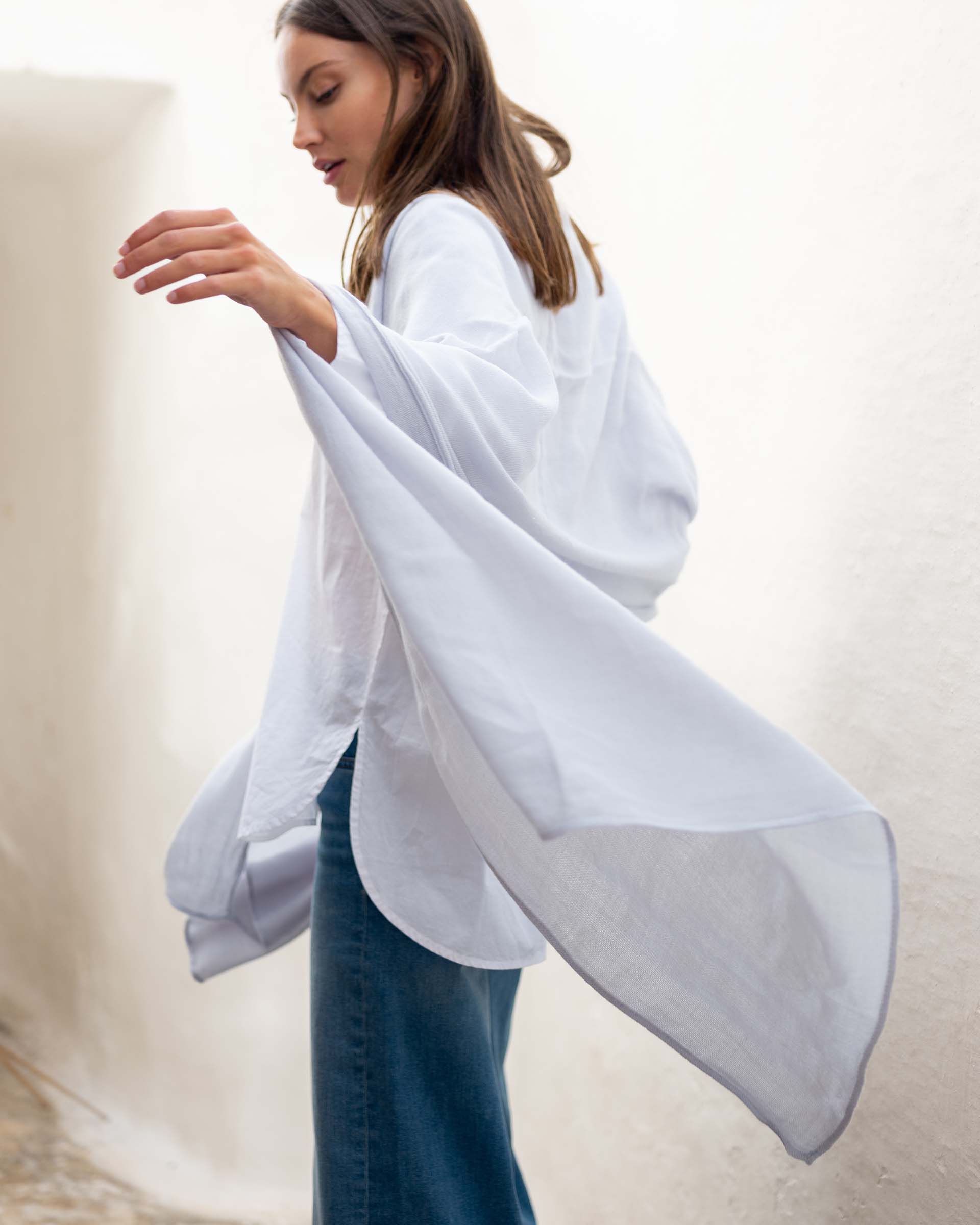 woman wearing golightly scarf in sky with arms swaying