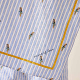 Fabric with blue and white striped pattern and small embroidered figures, featuring the brand 'Oceans of Love'.