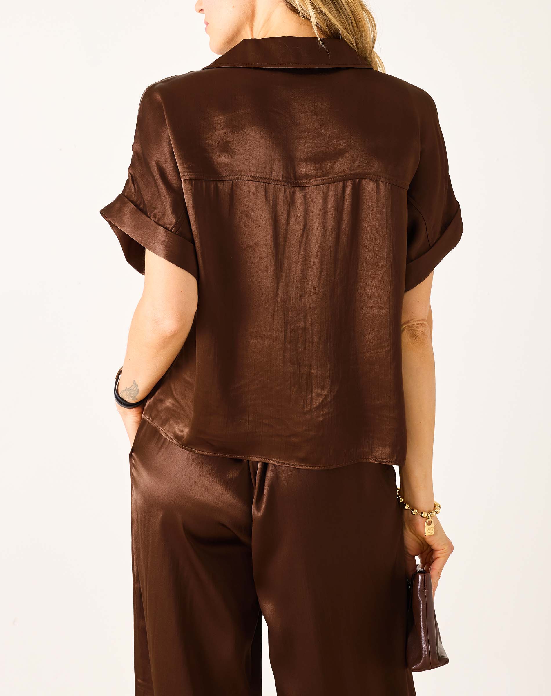 Chocolate brown boxy silk top with short sleeves and a wide neckline.