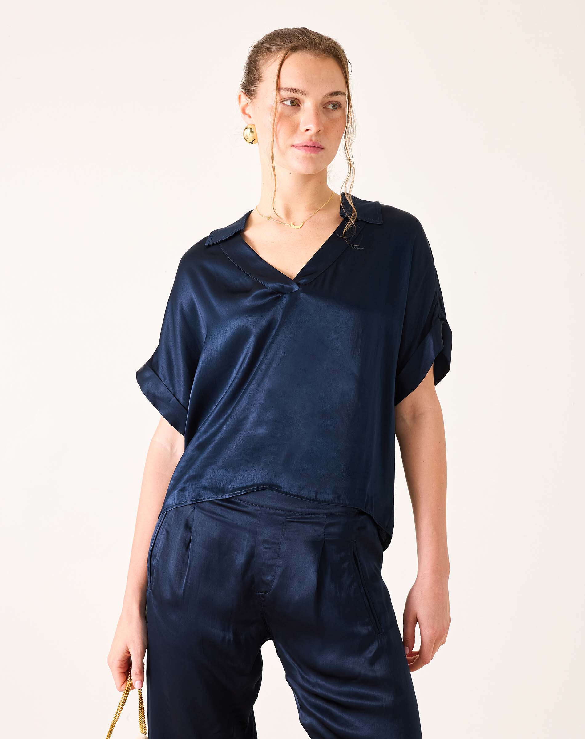 Navy blue boxy silk blend top with short sleeves and a split neckline.