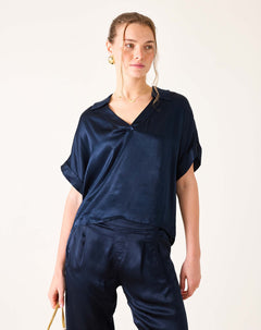 Navy blue boxy silk blend top with short sleeves and a split neckline.