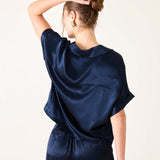 Navy blue boxy satin top with short sleeves and a soft sheen.