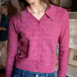 Rhubarb pink button-down knit sweater with a collar and ribbed texture.