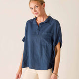 Woman wearing a blue shirt with a plain background