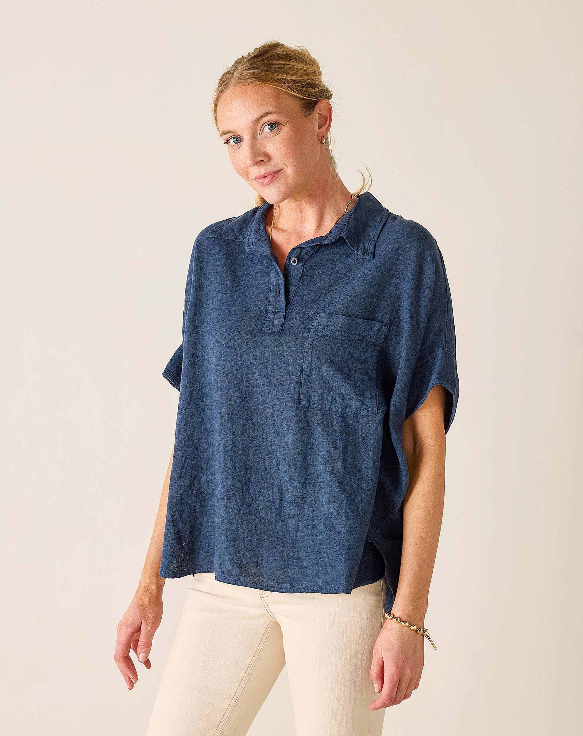 Woman wearing a blue shirt with a plain background