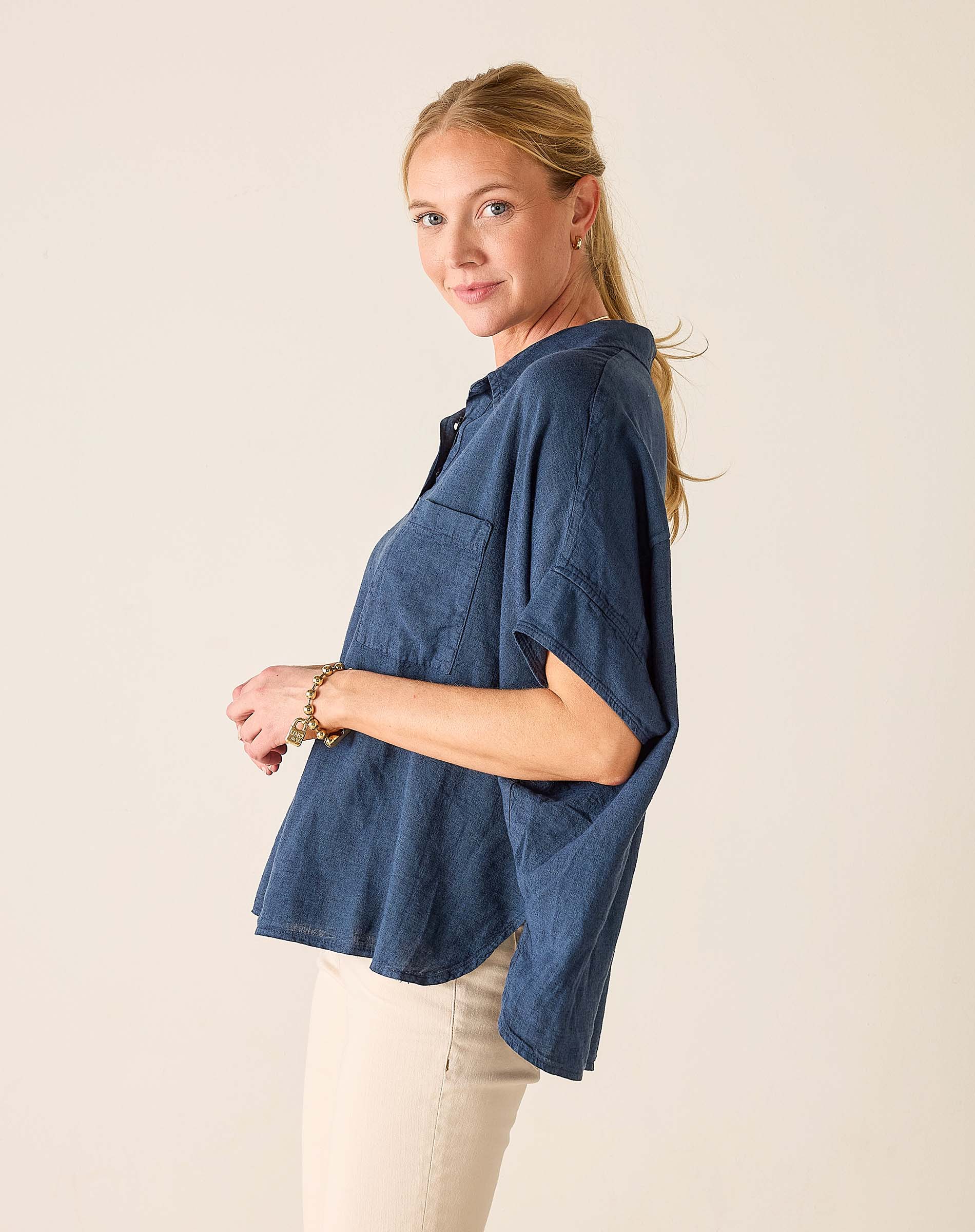 Woman wearing a blue shirt with a plain background