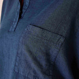 Close-up of a blue denim shirt with a pocket