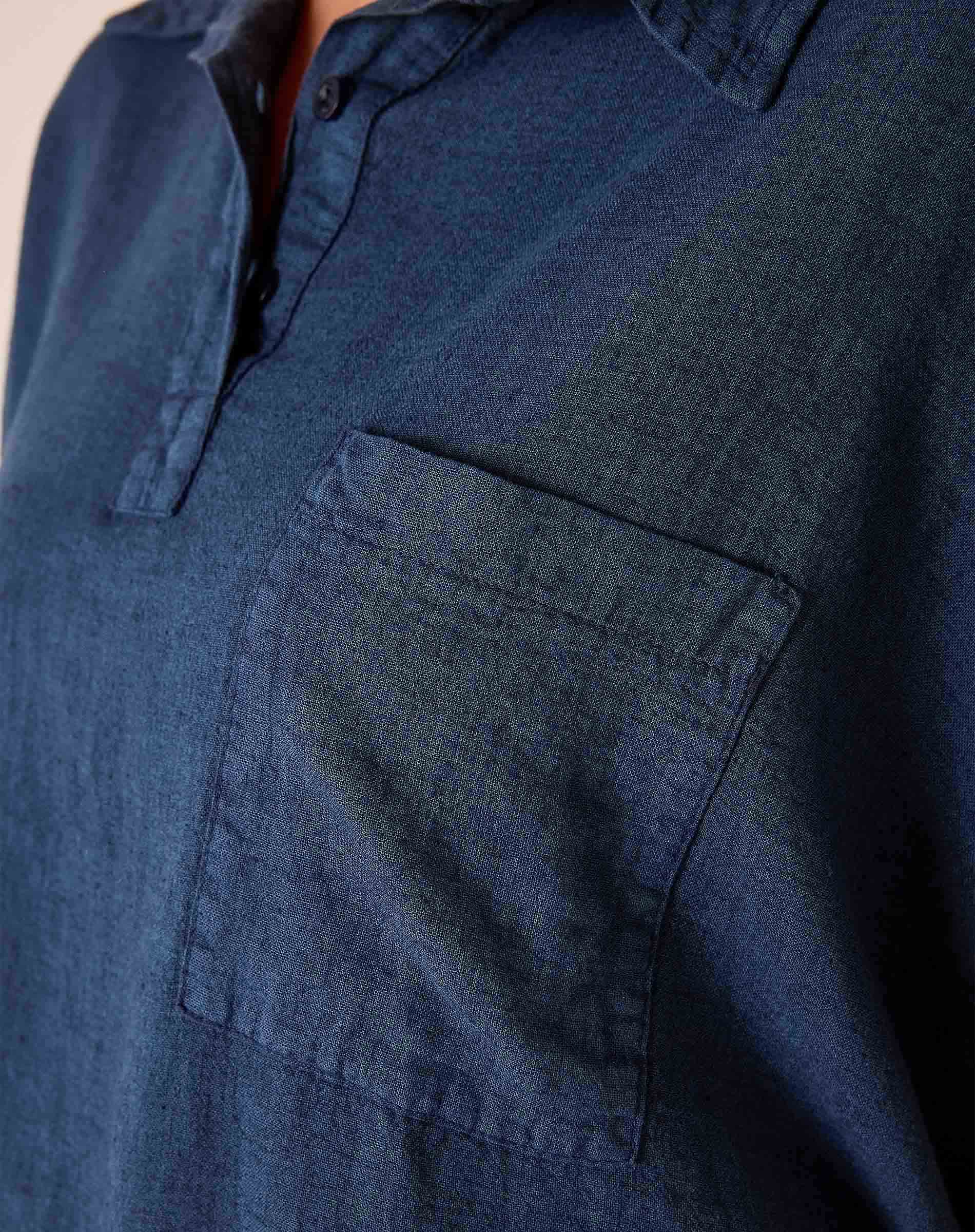 Close-up of a blue denim shirt with a pocket