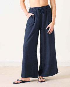 Navy wide-leg pants worn by a person on a plain background