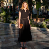 Black linen blend maxi dress with a v-neckline and tie-waist detail.