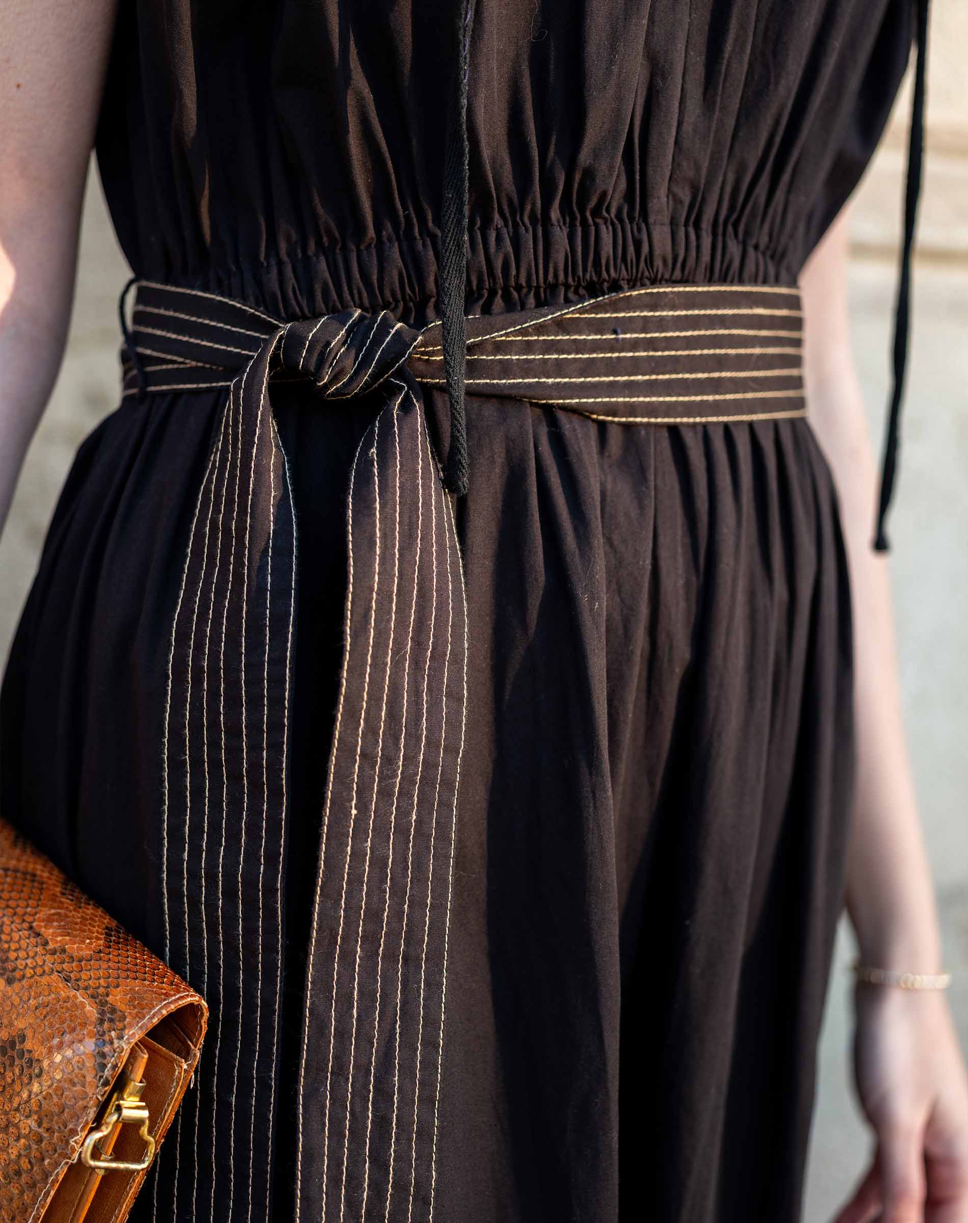 Black linen-blend dress with striped woven belt.