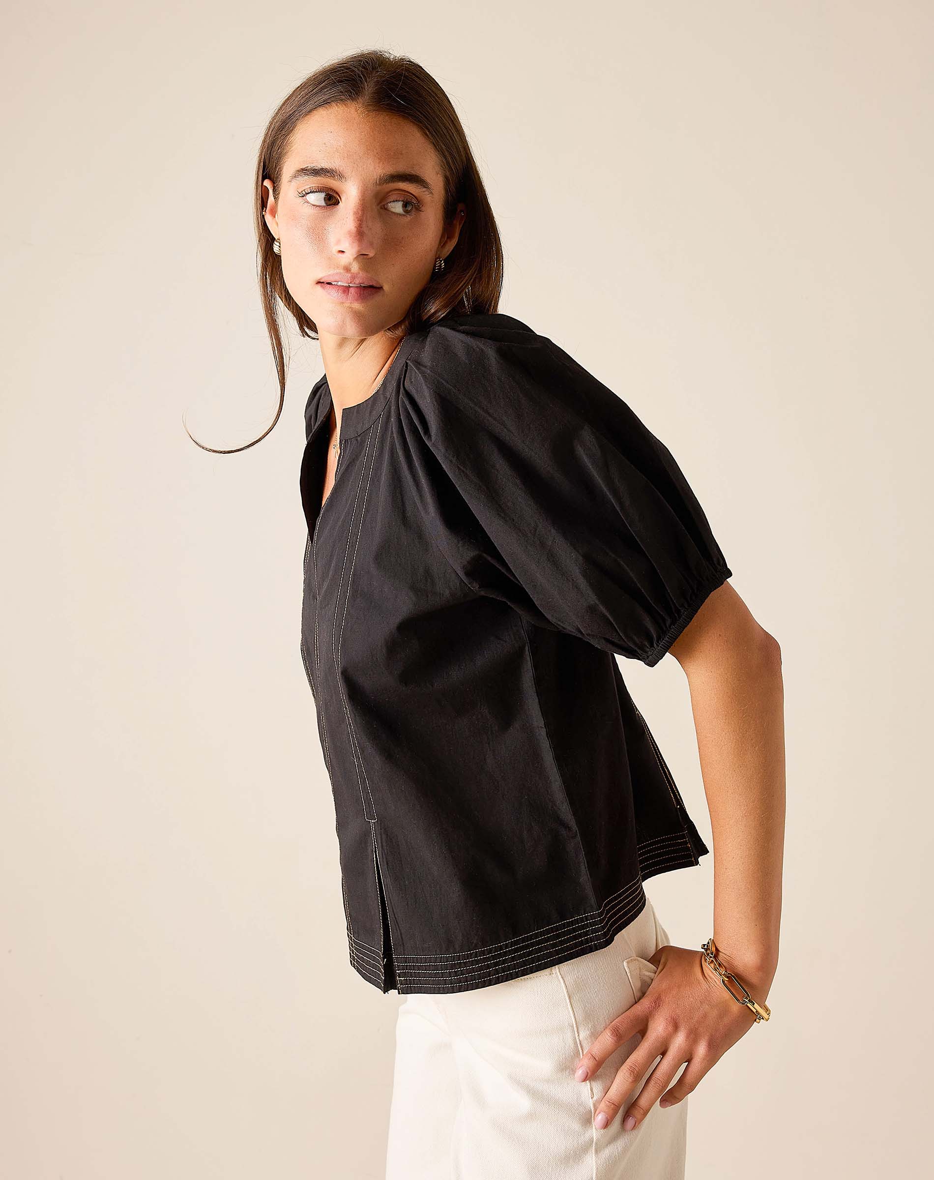 Black relaxed fit cotton blend tunic top with puff sleeves and stitch detail.