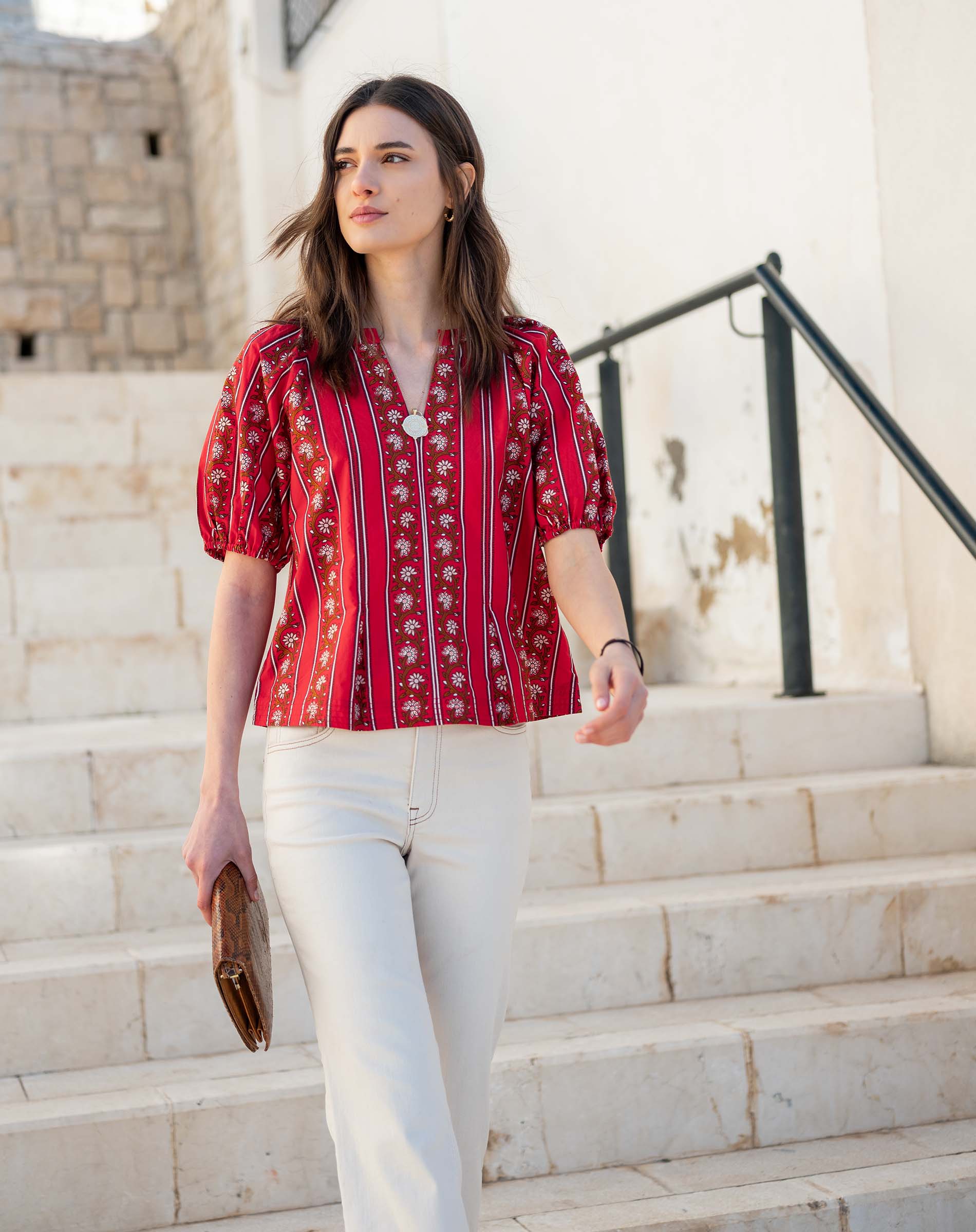 Crimson striped blouse with flutter sleeves and a ruffled placket detail.