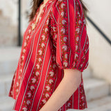 Crimson and cream striped top with puff sleeves and floral embroidery.