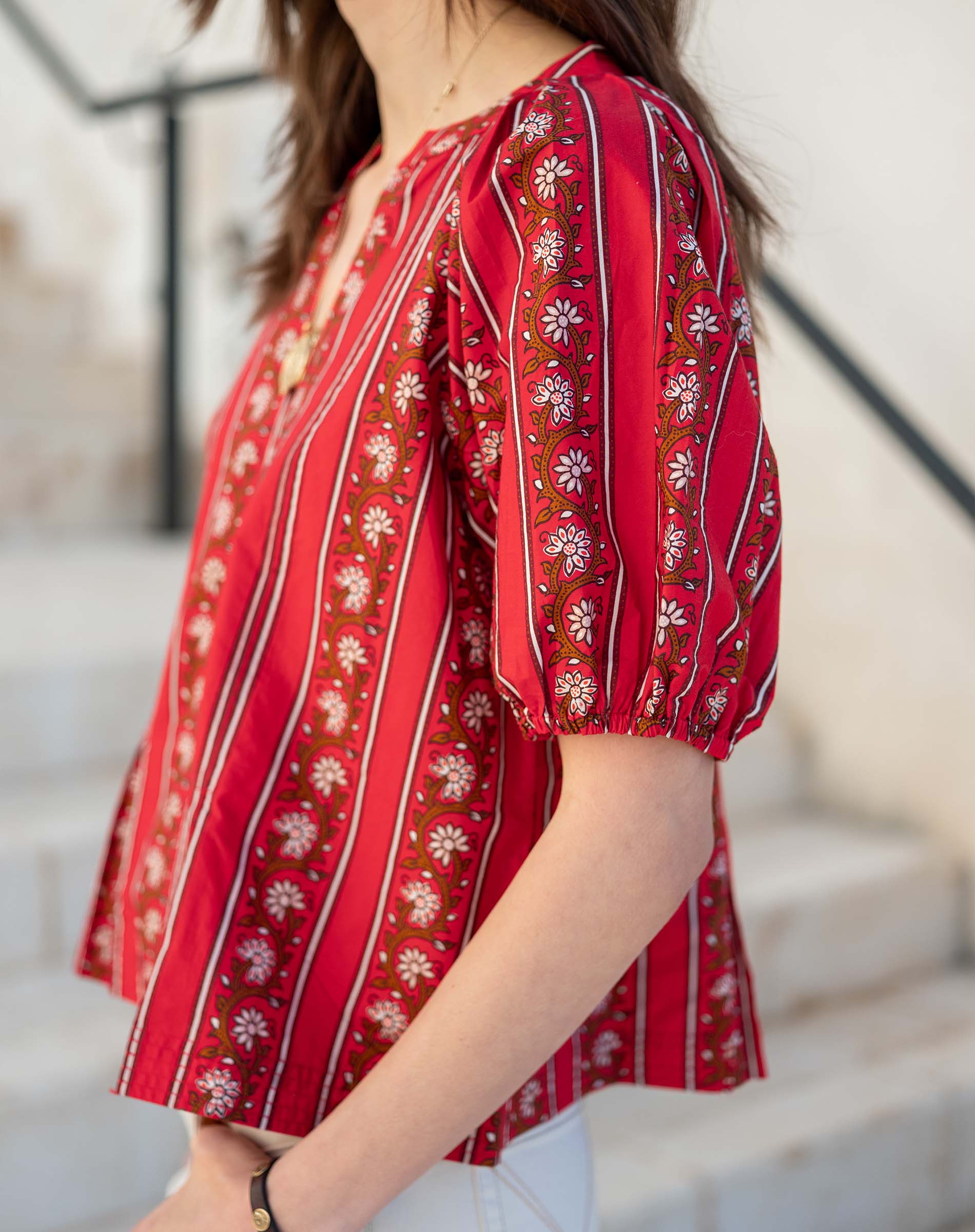 Crimson and cream striped top with puff sleeves and floral embroidery.