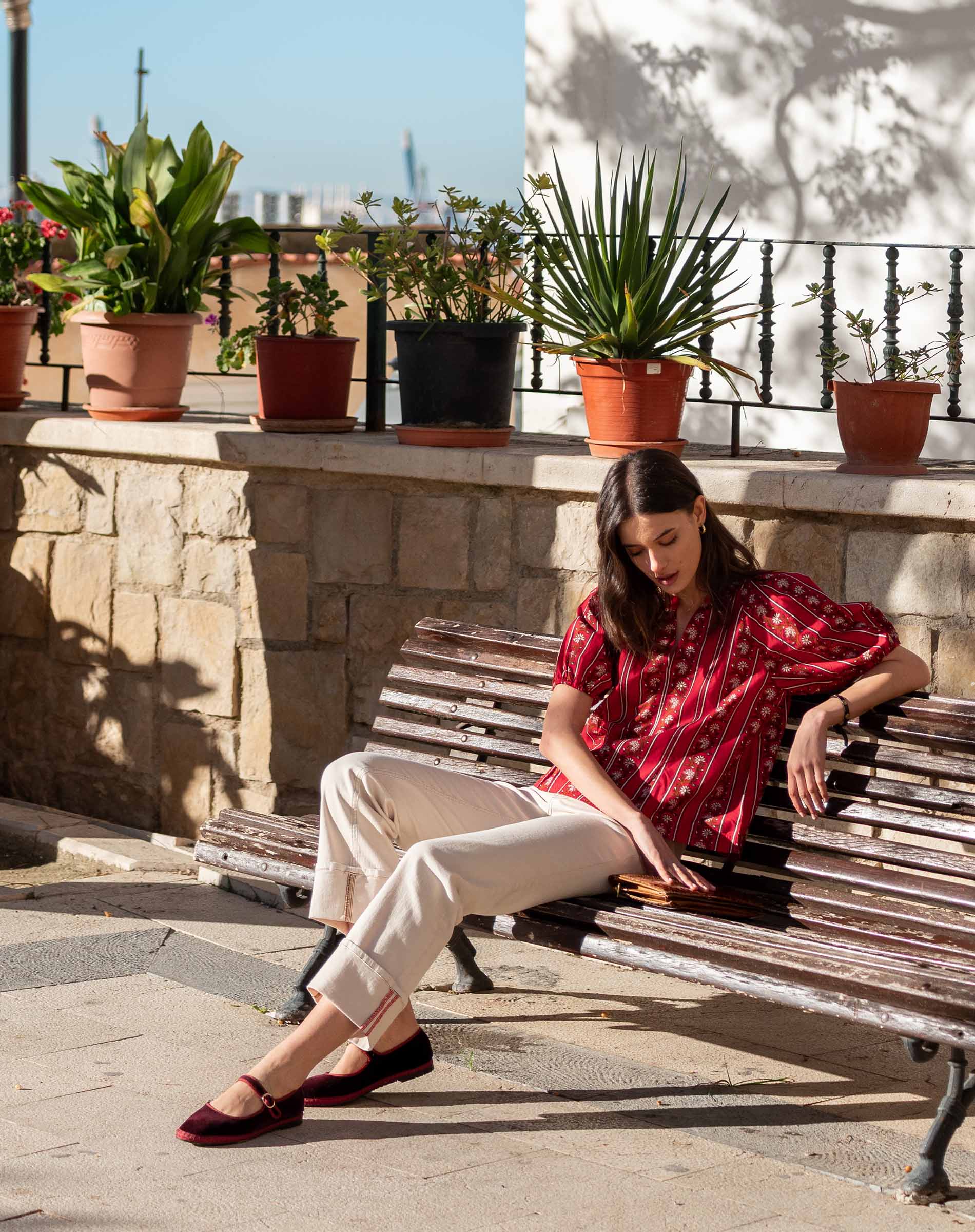 Crimson striped relaxed-fit blouse with short sleeves.