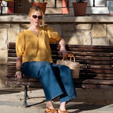 Ladies' travel-ready golden rod blouse with puffed sleeves and a V-neckline.