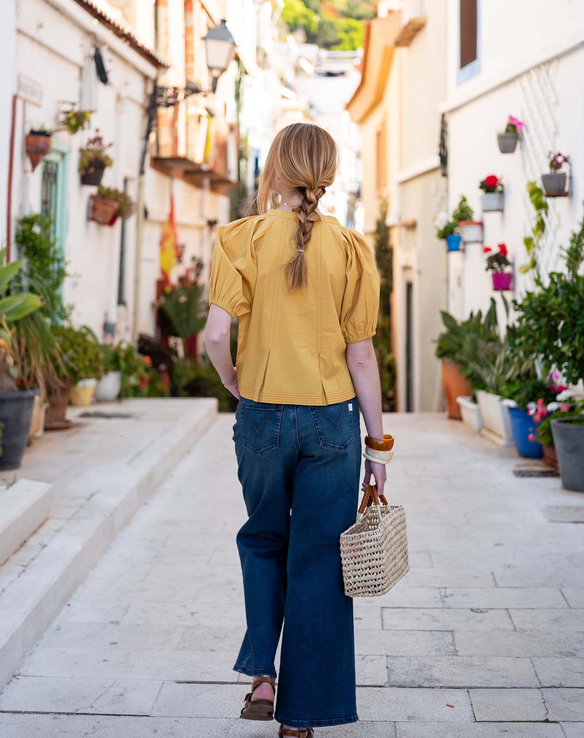Golden rod puff-sleeve blouse in a soft cotton blend with a gathered waist and relaxed fit.