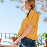 Golden rod puffed sleeve top in a lightweight fabric.