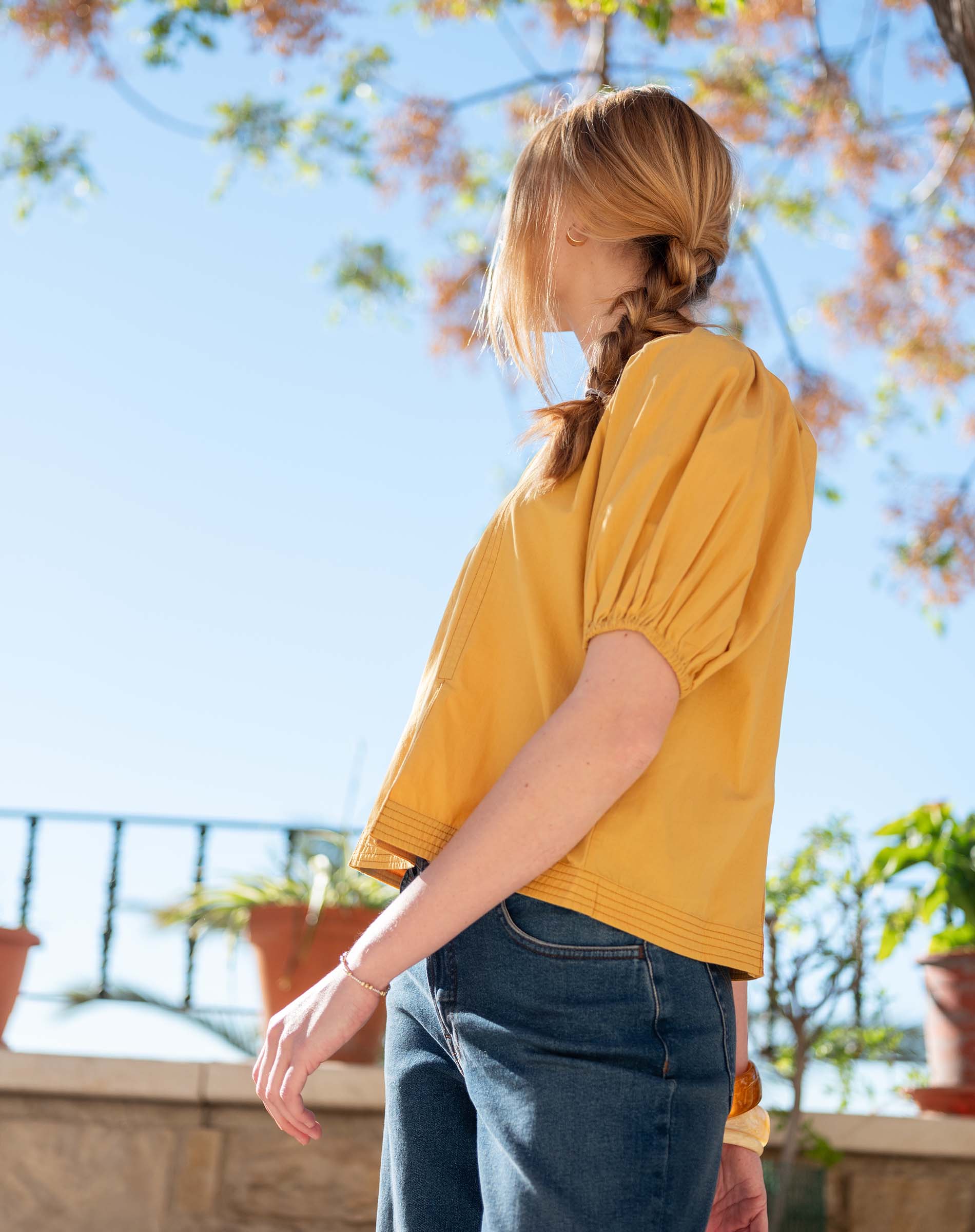 Golden rod puffed sleeve top in a lightweight fabric.
